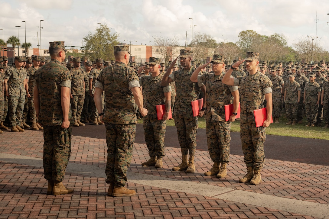 U.S. Marines stationed at Marine Corps Support Facility New Orleans, are meritoriously promoted during a visit from by Sgt. Maj. Carlos A. Ruiz, the 20th Sergeant Major of the Marine Corps, at the Marine Corps Support Facility New Orleans, March 10, 2026. Ruiz visited the facility as part of the SMMC Force Level Summit. (U.S. Marine Corps photo by Lance Cpl. Edward Spears)