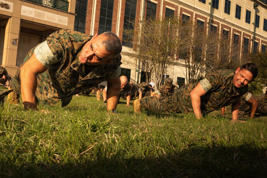 U.S. Marine Corps Sgt. Maj. Edwin A. Mota, left, command senior enlisted leader of Marine Forces Reserve and Marine Forces South and U.S. Marine Corps Sgt. Maj. Carlos A. Ruiz, the 20th Sergeant Major of the Marine Corps, right, do push-ups with Marines at Marine Corps Support Facility New Orleans, March 10, 2026. Ruiz visited the facility as part of the SMMC Force Level Summit. ( U.S. Marine Corps photo by Lance Cpl. Edward Spears)