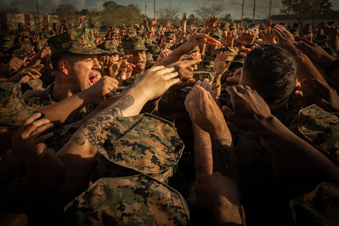 U.S. Marine Corps Sgt. Maj. Carlos A. Ruiz, the 20th Sergeant Major of the Marine Corps, calls Marines into a huddle at Marine Corps Support Facility New Orleans, March 10, 2026. Ruiz visited the facility as part of the SMMC Force Level Summit. (U.S. Marine Corps photo by Lance Cpl. Edward Spears)