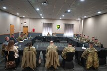 U.S. Air Force Maj. Gen. Stacy Jo Huser, 20th Air Force commander, and Chief Master Sgt. Nicholas Taylor, 20th Air Force command chief, eat lunch with 91st Missile Wing annual award winners at Minot Air Force Base, North Dakota, March 23, 2026. The 20th Air Force commander is also the commander of Task Force 214, which provides alert intercontinental ballistic missile weapon system to the United States Strategic Command. (U.S. Air Force photo by Airman 1st Class Anthony Ramey)