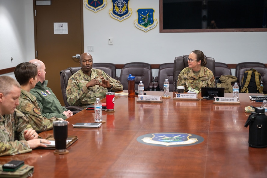 U.S. Air Force Maj. Gen. Stacy Jo Huser, 20th Air Force commander, and Chief Master Sgt. Nicholas Taylor, 20th Air Force command chief, meet with leadership from the 91st Missile Wing at Minot Air Force Base, North Dakota, March 23, 2026. In addition to observing current operations, the command team was briefed on ongoing modernization efforts across the installation. (U.S. Air Force photo by Airman 1st Class Anthony Ramey)