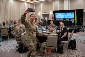 U.S. Air Force Lt. Col. Puneet Pande, 349th Medical Squadron dentist, takes a selfie with a group of U.S. Air Force Airmen participating in the Lesser Antilles Medical Assistance Team (LAMAT) mission in Georgetown, Guyana, March 16, 2026. LAMAT missions are part of a broader Health Security Cooperation initiative led by Air Forces Southern that integrates U.S. military medical services with host nation providers.  (U.S. Air Force photo by Master Sgt. Albert Rullan)