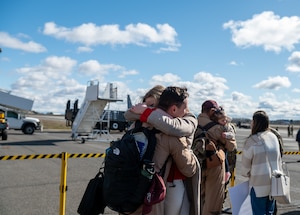 A member of the 92nd Air Refueling Wing embraces his spouse.