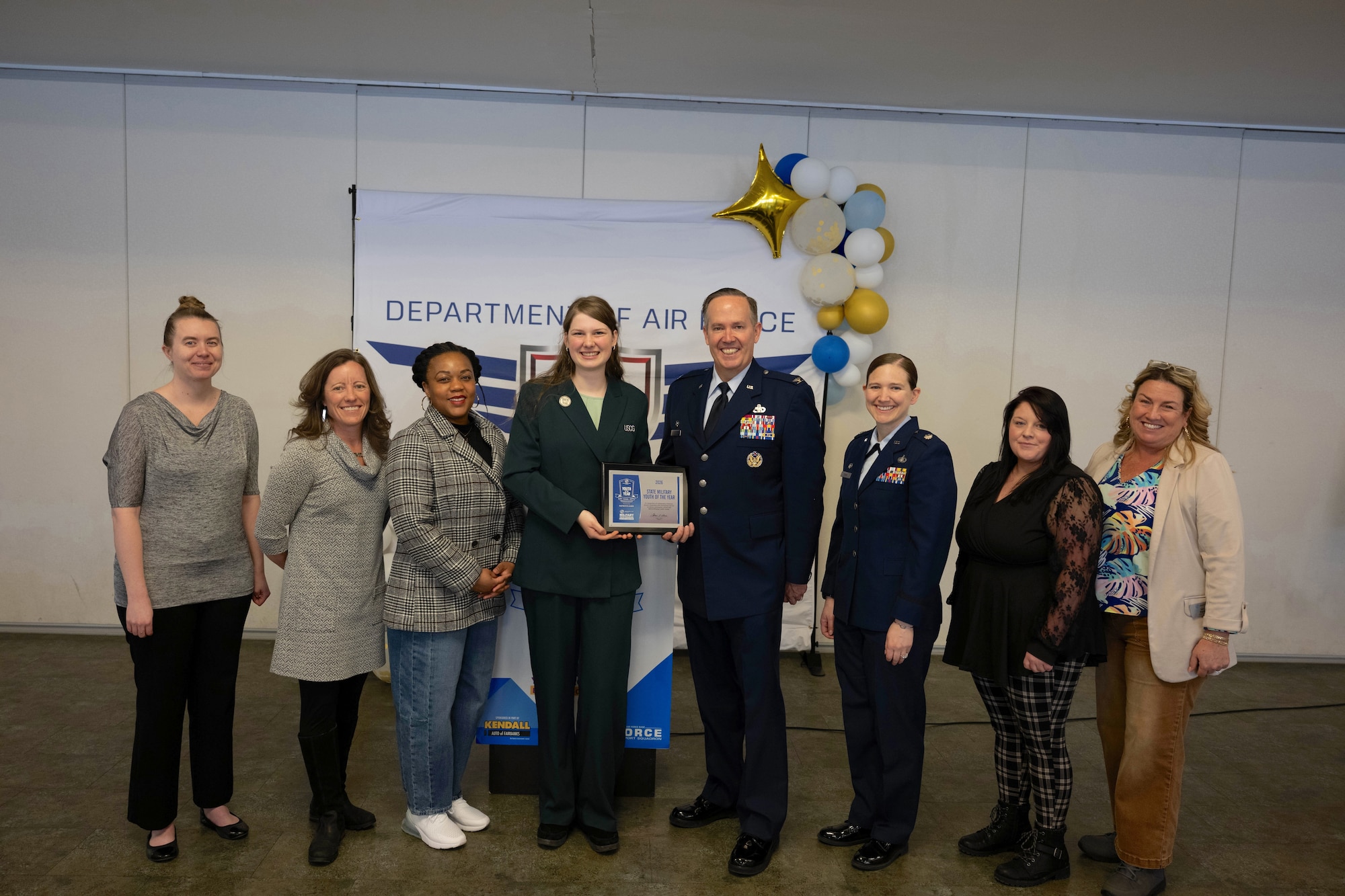 U.S. Air Force Col. Timothy Foster, 354th mission support group commander, presents Youth of the Year award to Lily-Ruth Hall, U.S. Coast Guard Kodiak youth program candidate, with accompanying judges from the Boy’s & Girl’s Club of America on Eielson Air Force Base, Alaska, March 21, 2026.