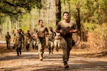 U.S. Airmen from Joint Base Charleston run with gas and ammo cans during the endurance course portion of the Airman Leadership School field training exercise at the Marine Corps Recruiting Depot, Parris Island, South Carolina.