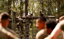 U.S. Airmen climb a rope ladder during the endurance course portion of the Airman Leadership School field training exercise at the Marine Corps Recruiting Depot, Parris Island, South Carolina.
