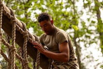 U.S. Air Force Senior Airman Julian Martin, 437th Aircraft Maintenance Squadron integrated capabilities command systems apprentice, climbs down a rope ladder during the endurance course portion of the Airman Leadership School field training exercise at the Marine Corps Recruiting Depot, Parris Island, South Carolina.