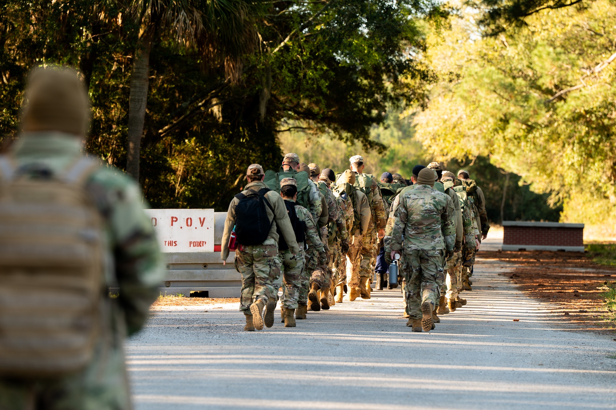 U.S. Marine Corps instructors lead U.S. Airmen and U.S. Coastguardsmen as they march in formation to the first phase of the obstacle course during an Airman Leadership School field training exercise at the Marine Corps Recruiting Depot, Parris Island, South Carolina.