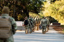 U.S. Marine Corps instructors lead U.S. Airmen and U.S. Coastguardsmen as they march in formation to the first phase of the obstacle course during an Airman Leadership School field training exercise at the Marine Corps Recruiting Depot, Parris Island, South Carolina.