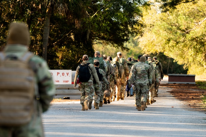 U.S. Marine Corps instructors lead U.S. Airmen and U.S. Coastguardsmen as they march in formation to the first phase of the obstacle course during an Airman Leadership School field training exercise at the Marine Corps Recruiting Depot, Parris Island, South Carolina.