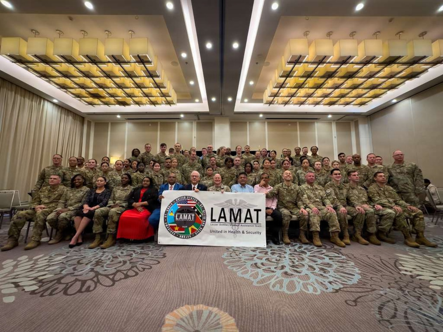U.S. and Guyanese officials gather for a group photo following the opening ceremony for the 2026 Lesser Antilles Medical Assistance Team (LAMAT) mission in Georgetown, Guyana, March 16, 2026. Over the next two weeks, a multi-disciplinary team of U.S. Air Force medical personnel will integrate with local providers in medical facilities across Georgetown, Linden, and West Demerara. (U.S. Air Force photo by Master Sgt. Albert Rullan)