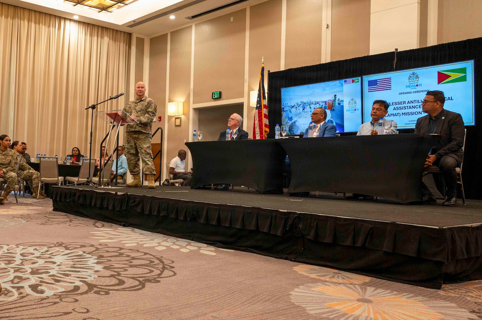U.S. Air Force Col. Ted Liszeski, Mission Commander for the Lesser Antilles Medical Assistance Team (LAMAT) mission in Guyana, delivers remarks during the opening ceremony for LAMAT26 in Georgetown, Guyana, March 16, 2026. The two-week mission brings together U.S. Air Force medical professionals and Guyanese healthcare providers to deliver specialized care while strengthening regional health resilience across the Cooperative Republic of Guyana. (U.S. Air Force photo by Maj. Stephani Schafer)