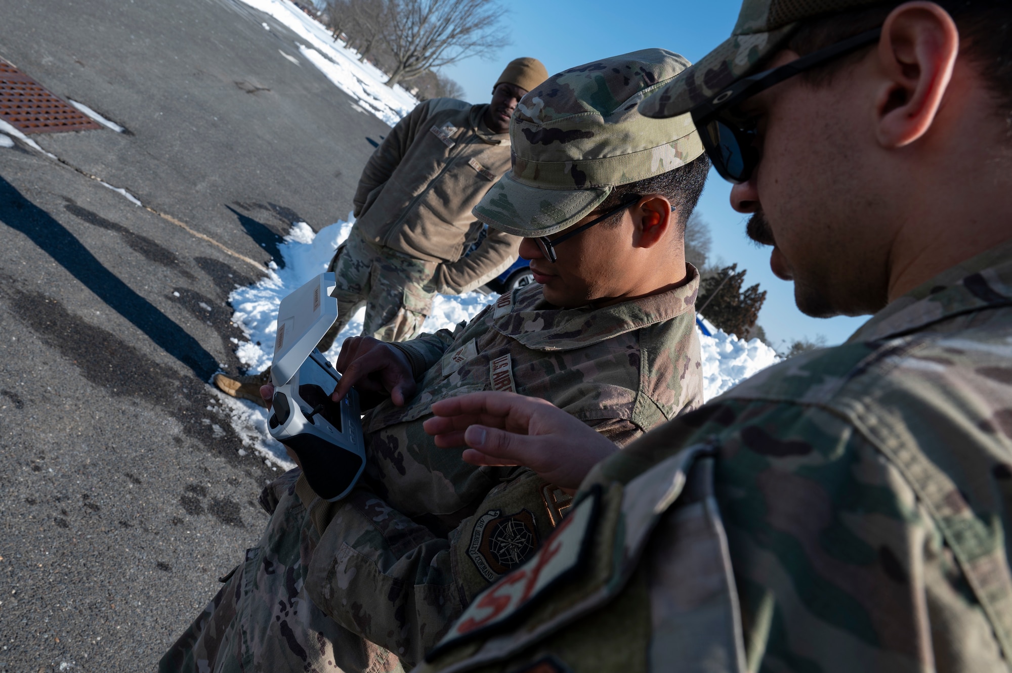 U.S. Air Force Senior Airman Jacob Bilyou (right), 723rd Combat Air Base Squadron Security Forces defender, instructs Senior Airman Jorge Jacamo, 723rd CABS electrical systems journeyman, as he operates a small Unmanned Aircraft System (sUAS) during a sUAS operator course at Joint Base McGuire-Dix-Lakehurst, N.J., Feb. 4, 2026.