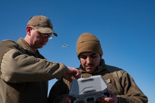 U.S. Air Force Staff Sgt. Derrick Downey (left), 87th Air Base Wing small Unmanned Aircraft System (sUAS) operations manager, instructs Senior Airman Jose Garcia Lopez, 723rd Combat Air Base Squadron cargo processing specialist, during a sUAS operation training course at Joint Base McGuire-Dix-Lakehurst, N.J., Feb. 4, 2026.