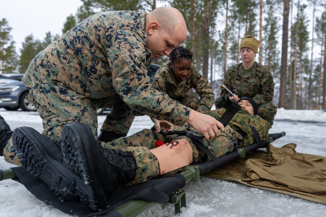 From left, U.S. Navy Hospital Corpsman 3rd Class Dairius Amos, with 2nd Battalion, 6th Marine Regiment, 2nd Marine Division; Hospitalman Shanira Evans, with 2nd Battalion, 6th Marine Regiment; and Hospital Corpsman 1st Class Morgan Jacobs, with Naval Medical Forces Atlantic, participate in a Marine Corps Warfighting Laboratory-led mass casualty drill during exercise Cold Response 26 in Setermoen, Norway, March 11, 2026. This drill was held to test medical modernization efforts focused on increasing survivability by pushing advanced care closer to the point of injury. A key component of NATO's enhanced vigilance activity Arctic Sentry, exercise Cold Response 26 is a Norwegian-led winter military exercise designed to enhance collective defense capabilities and ensure U.S. readiness to rapidly deploy and seamlessly operate alongside NATO Allies in challenging arctic conditions. (U.S. Marine Corps photo by Cpl. Michael Bartman)