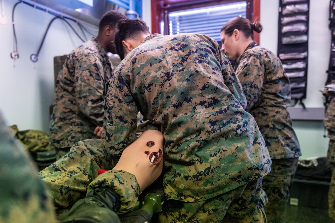 From left, Hospital Corpsman 3rd Class Nicky Fred Gikoro, Hospital Corpsman 3rd Class Joseph Dominguez, and U.S. Navy Lt. Cmdr. Lisa Talledo, an ER trauma nurse,all with 2nd Battalion, 6th Marine Regiment, 2nd Marine Division, treat a simulated patient during a Marine Corps Warfighting Laboratory-led mass casualty drill as part of exercise Cold Response 26 in Setermoen, Norway, March 11, 2026. This drill was held to test medical modernization efforts focused on increasing survivability by pushing advanced care closer to the point of injury. A key component of NATO's enhanced vigilance activity Arctic Sentry, exercise Cold Response 26 is a Norwegian-led winter military exercise designed to enhance collective defense capabilities and ensure U.S. readiness to rapidly deploy and seamlessly operate alongside NATO Allies in challenging arctic conditions. (U.S. Marine Corps photo by Cpl. Michael Bartman)