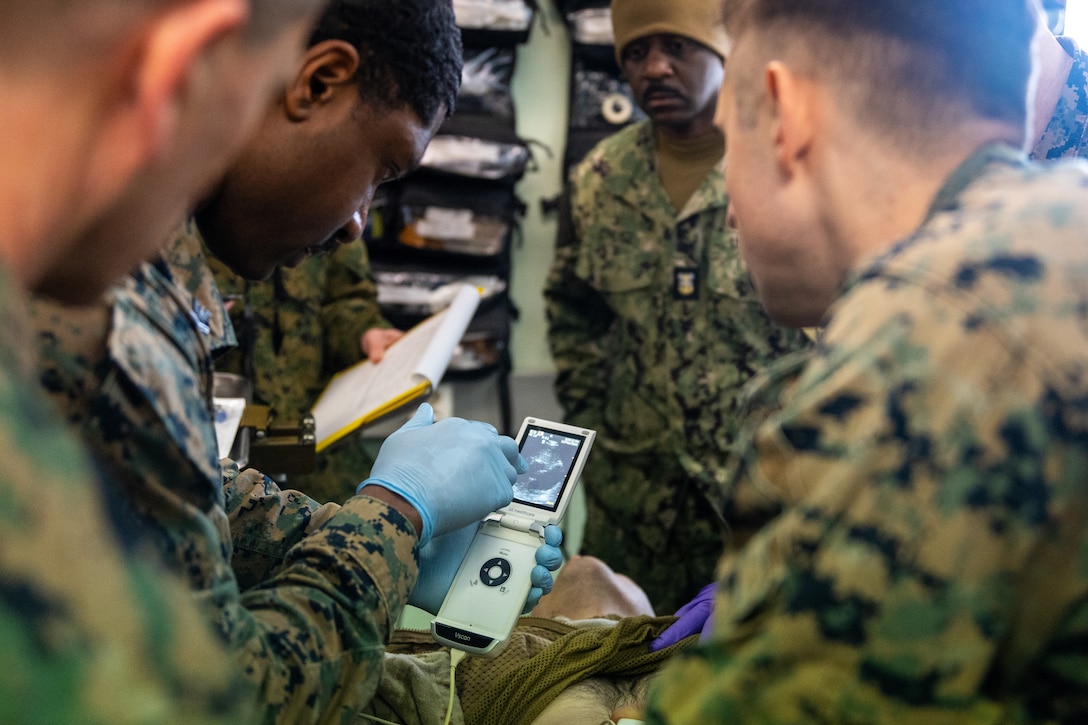 U.S. Navy Corpsmen and medical providers with 2nd Battalion, 6th Marine Regiment, 2nd Marine Division, use a handheld ultrasound to treat a simulated patient during a Marine Corps Warfighting Laboratory-led mass casualty drill as part of exercise Cold Response 26 in Setermoen, Norway, March 11, 2026. The training allowed the medical team to test handheld ultrasound devices, which are designed to provide rapid diagnostic capabilities in austere environments. A key component of NATO's enhanced vigilance activity Arctic Sentry, exercise Cold Response 26 is a Norwegian-led winter military exercise designed to enhance collective defense capabilities and ensure U.S. readiness to rapidly deploy and seamlessly operate alongside NATO Allies in challenging arctic conditions. (U.S. Marine Corps photo by Cpl. Michael Bartman)