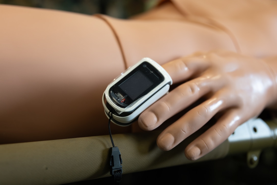 U.S. Navy Corpsmen with 2nd Battalion, 6th Marine Regiment, 2nd Marine Division, monitor a simulated patient’s aftercare vitals with a pulse oximeter during a Marine Corps Warfighting Laboratory-led mass casualty drill as part of exercise Cold Response 26 in Setermoen, Norway, March 11, 2026. The drill was held to test the corpsmen's ability to monitor patient vitals using modern medical devices in a simulated Arctic combat environment. A key component of NATO's enhanced vigilance activity Arctic Sentry, exercise Cold Response 26 is a Norwegian-led winter military exercise designed to enhance collective defense capabilities and ensure U.S. readiness to rapidly deploy and seamlessly operate alongside NATO Allies in challenging arctic conditions. (U.S. Marine Corps photo by Cpl. Michael Bartman)