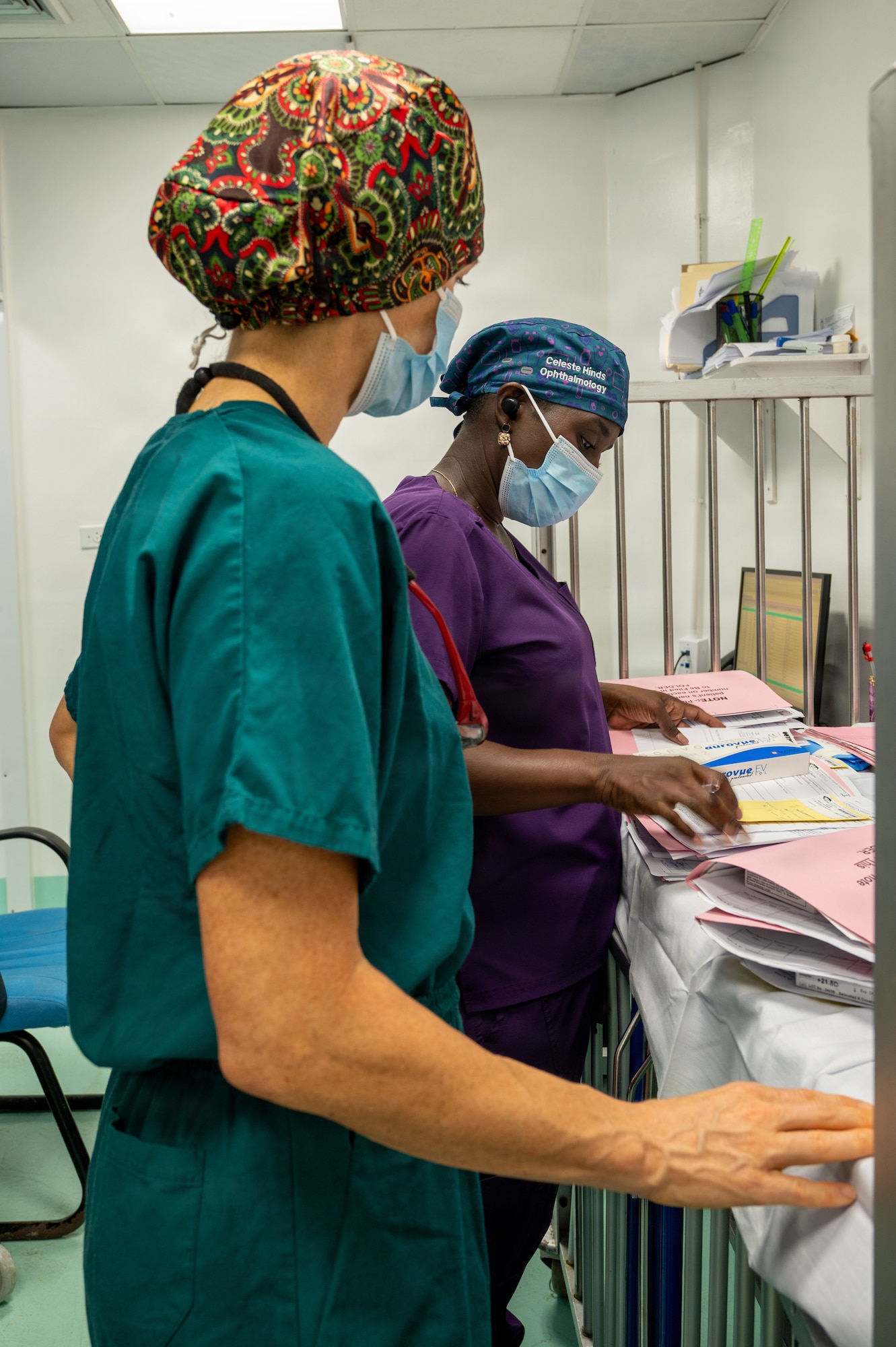 U.S. Air Force Lt. Col. Jessica Bolton, 96th Medical Group ophthalmologist, front, and Dr. Celeste Hines, Guyanese ophthalmologist, review patient records prior to beginning ophthalmological procedures at the Georgetown Public Hospital Corporation in Georgetown, Guyana, March 18, 2026. During the Lesser Antilles Medical Assistance Team (LAMAT) 2026 mission, U.S. Air Force ophthalmology teams performed critical eye procedures alongside Ministry of Health providers, enhancing surgical readiness while improving vision outcomes and strengthening enduring partnerships. (U.S. Air Force photo by Maj. Stephani Schafer)