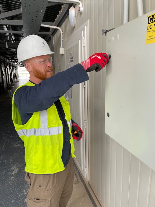 A Task Force SAFE electrician unlocks a panel to conduct an inspection at Tower 22 (Rukban), a small logistics base in northeastern Jordan near the Syria-Iraq border.