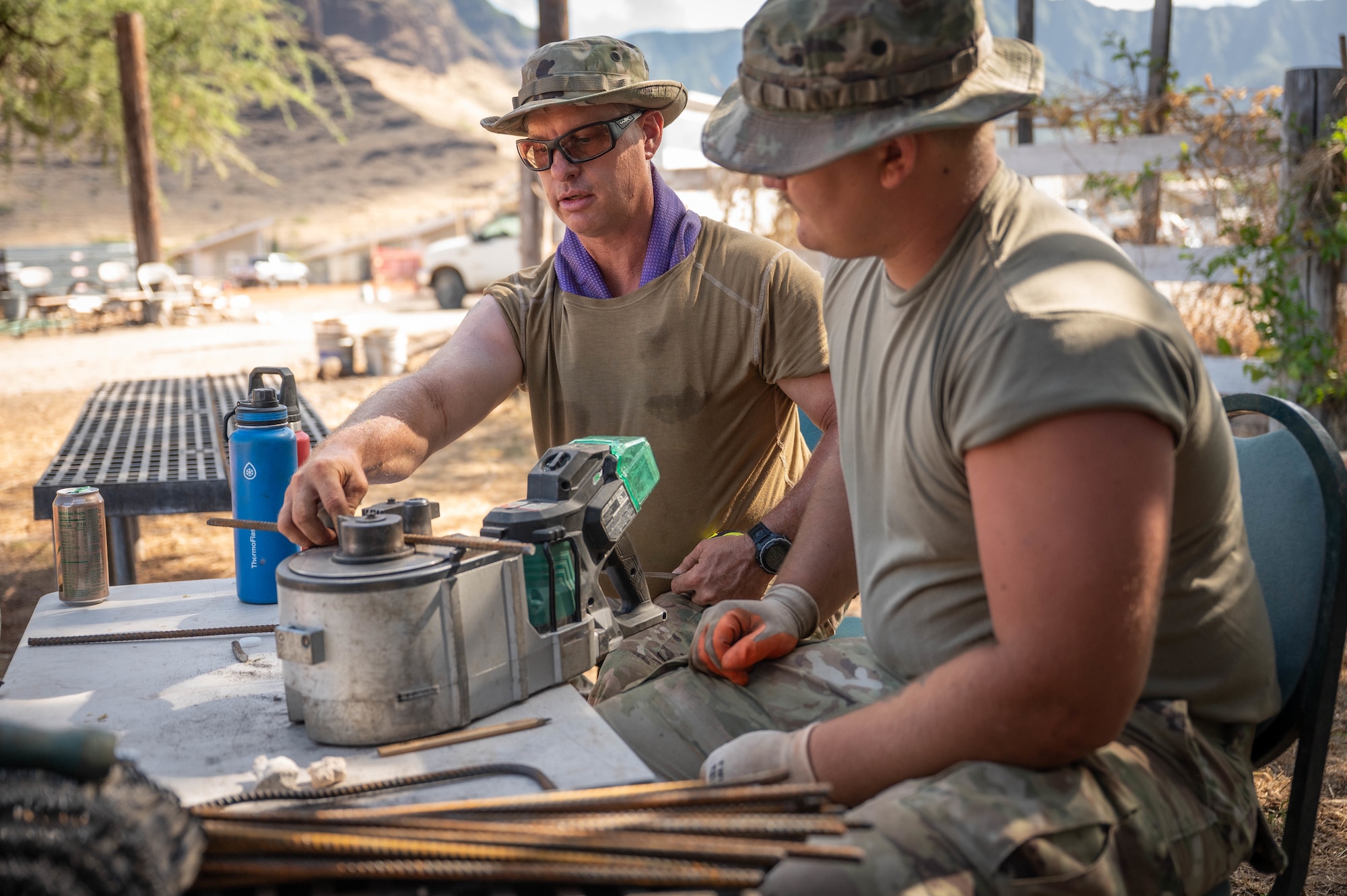 Two Airmen working with rebar.
