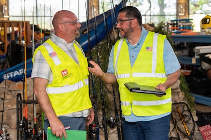 Sean Yoder, left, Family Readiness coordinator, and George Romero, 502d Force Support Group operations specialist, discuss exercise procedures during an Emergency Resilience Readiness Exercise at Joint Base San Antonio-Lackland, Texas, March 24, 2026. JBSA conducted a preplanned exercise March 24–27 to ensure personnel are prepared to respond to a potential severe weather event and widespread power outage. (U.S. Air Force photo by Marcus Robins)