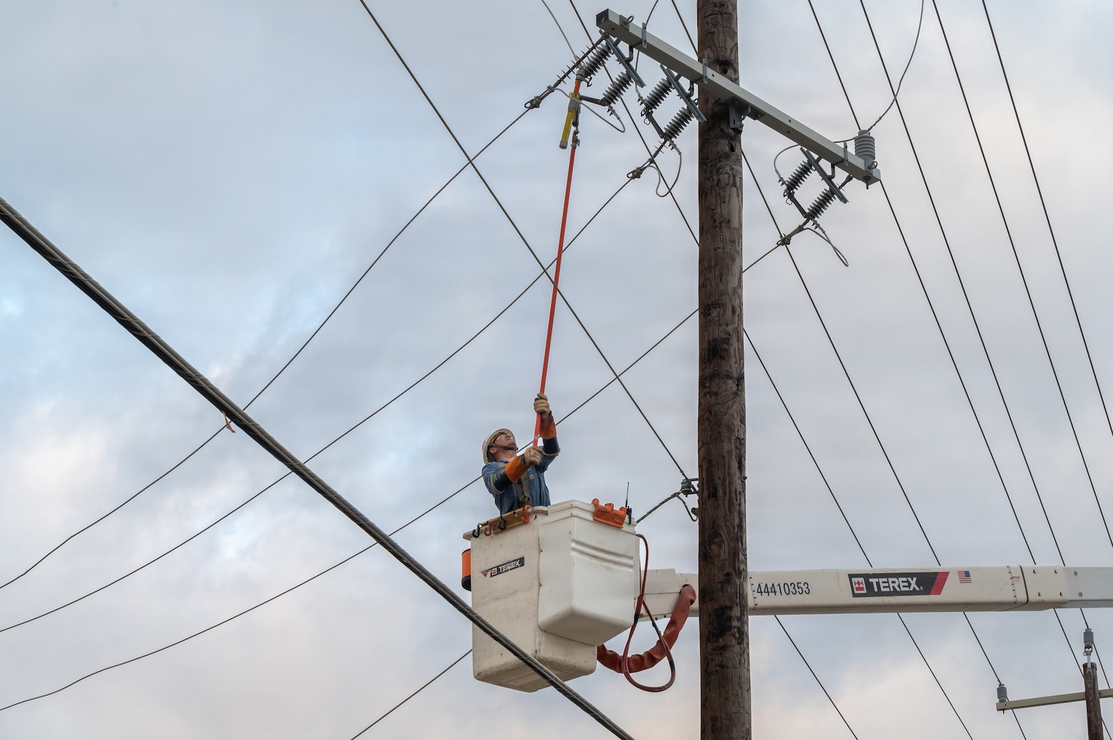 Edgar Esparza, CPS Energy journeyman lineman, disconnects electrical power from a utility pole during an Emergency Resilience Readiness Exercise at Joint Base San Antonio-Lackland, Texas, March 26, 2026. JBSA conducted a preplanned exercise March 24–27 to ensure personnel are prepared to respond to a potential severe weather event and widespread power outage. (U.S. Air Force photo by Marcus Robins)