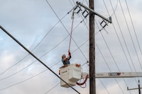 Edgar Esparza, CPS Energy journeyman lineman, disconnects electrical power from a utility pole during an Emergency Resilience Readiness Exercise at Joint Base San Antonio-Lackland, Texas, March 26, 2026. JBSA conducted a preplanned exercise March 24–27 to ensure personnel are prepared to respond to a potential severe weather event and widespread power outage. (U.S. Air Force photo by Marcus Robins)