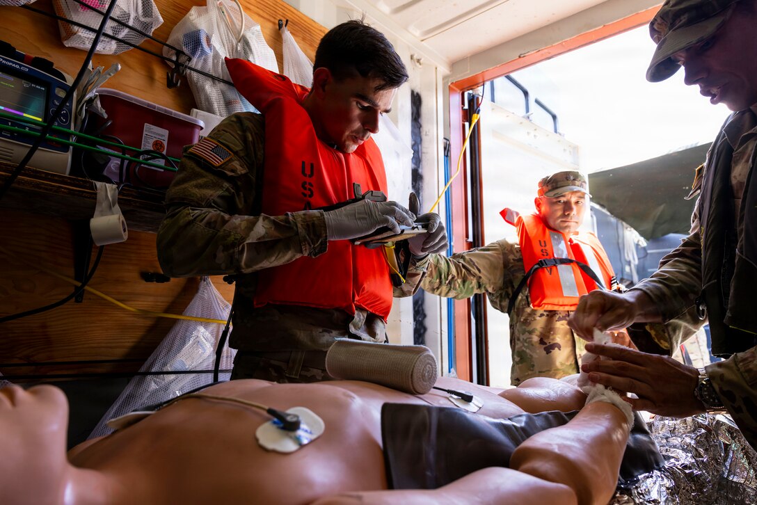 U.S. Army combat medics, assigned to the 8th Forward Resuscitative Surgical Detachment, utilize the Battlefield Assisted Trauma Distributed Observation Kit - Joint system to document care for a simulated patient during an external evaluation and demonstration of littoral medical operations aboard the U.S. Army Vessel SSG Elroy F. Wells (MSV(L)-01) off the shore of Joint Base Pearl Harbor-Hickam, March 24, 2026.