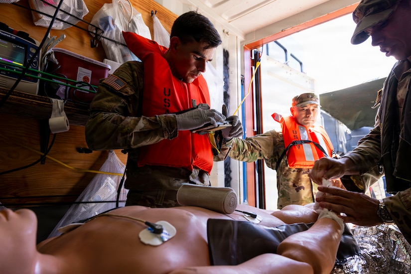 U.S. Army combat medics, assigned to the 8th Forward Resuscitative Surgical Detachment, utilize the Battlefield Assisted Trauma Distributed Observation Kit - Joint system to document care for a simulated patient during an external evaluation and demonstration of littoral medical operations aboard the U.S. Army Vessel SSG Elroy F. Wells (MSV(L)-01) off the shore of Joint Base Pearl Harbor-Hickam, March 24, 2026.