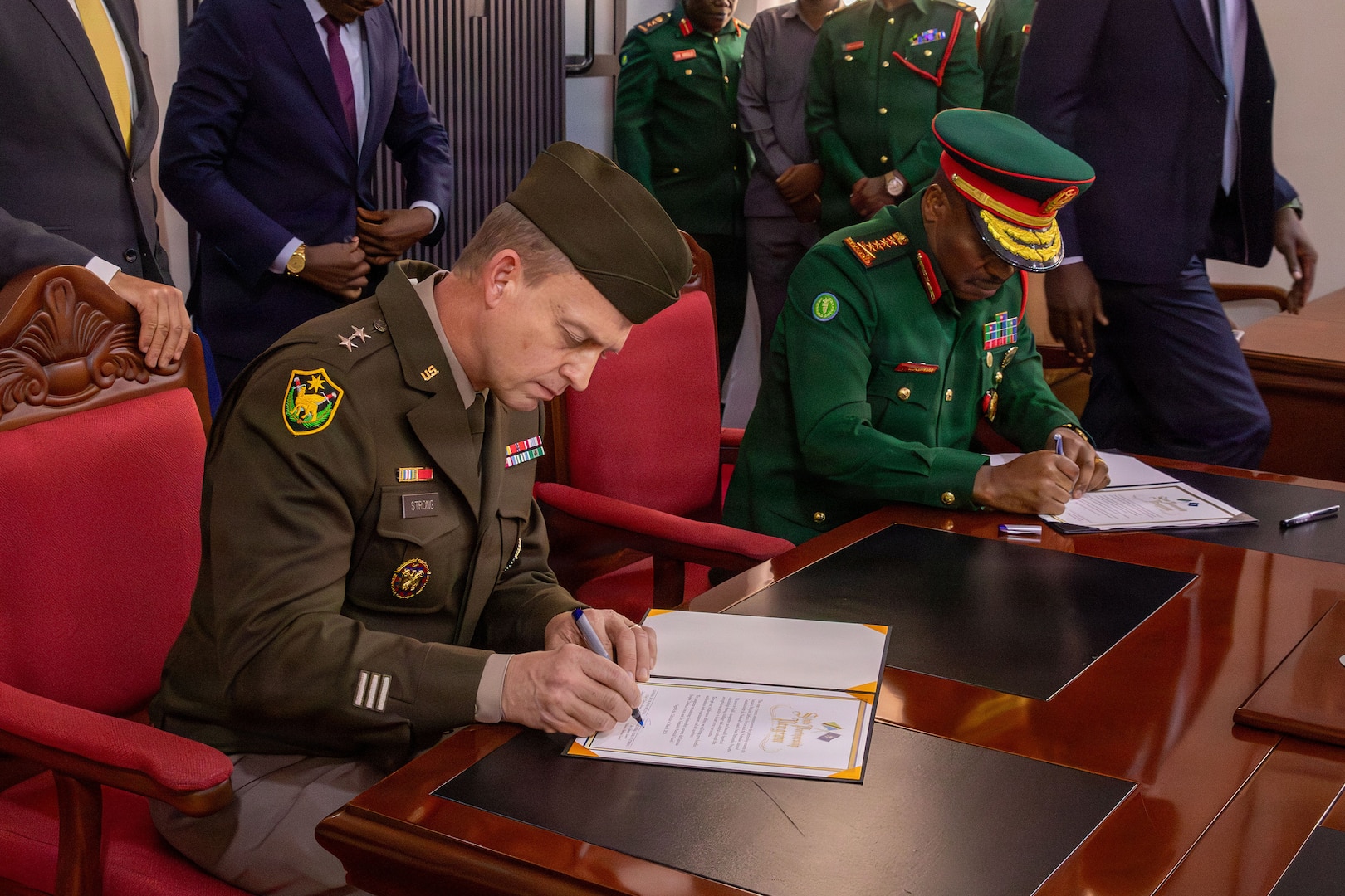 U.S. Army Maj. Gen. Craig Strong, left, Nebraska’s adjutant general, and Gen. Jacob John Mkunda, chief of defense forces for the Tanzania Peoples’ Defence Forces, sign a formal letter of intent in Dar es Salaam, Tanzania, March 12, 2026.