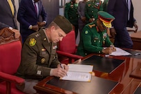 U.S. Army Maj. Gen. Craig Strong, left, Nebraska’s adjutant general, and Gen. Jacob John Mkunda, chief of defense forces for the Tanzania Peoples’ Defence Forces, sign a formal letter of intent in Dar es Salaam, Tanzania, March 12, 2026.