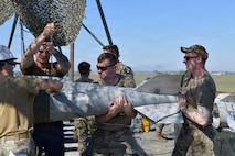 Airmen, Marines and Sailors prepared live munitions to support 24-hour sortie requirements while strengthening mission-critical skills. With its first class held in 1986, AFCOMAC celebrated its 40th anniversary with the graduation of class 2026-004. (U.S. Air Force photo by 1st Lt. Sharon Kinghorn)