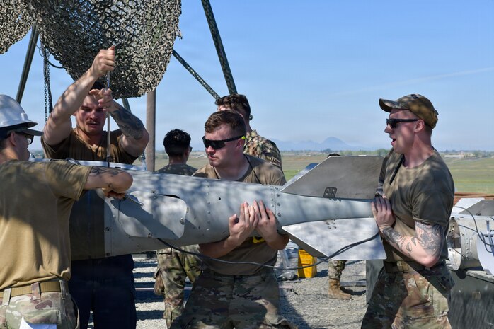 Airmen, Marines and Sailors prepared live munitions to support 24-hour sortie requirements while strengthening mission-critical skills. With its first class held in 1986, AFCOMAC celebrated its 40th anniversary with the graduation of class 2026-004. (U.S. Air Force photo by 1st Lt. Sharon Kinghorn)