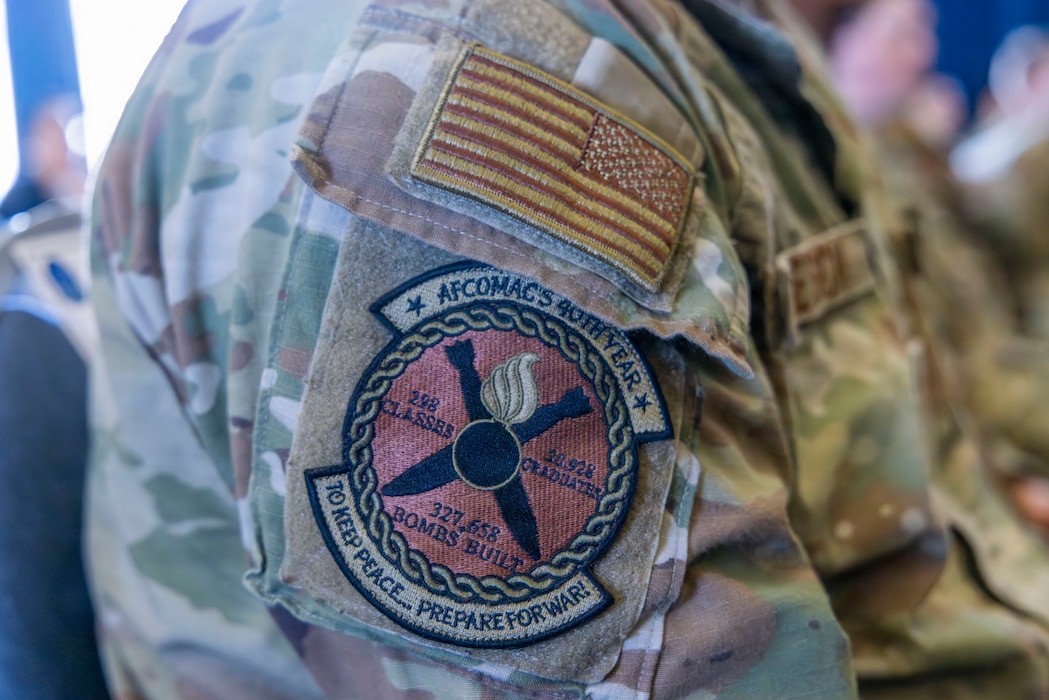 AFCOMAC provides advanced training in mass combat ammunition planning and production, preparing personnel to establish bomb dumps and build thousands of live munitions in realistic, bare-base scenarios through its Combat Ammunition and Production (CAPP) course and Senior Leader Aerial Munitions Course (SLAM-C). AFCOMAC class 2026-004 consisted of a joint force featuring Airmen, Sailors and Marines and broke the AFCOMAC record for the highest amount of munitions built, 915, along with the fewest discrepancies. (U.S. Air Force photo by Senior Airman Frederick A. Brown)