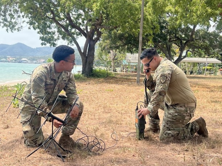 U.S. Army Spc. Kevin Mercedes and U.S. Army Sgt. Andrew Kundrick, 2nd Joint Communications Squadron, Joint Communications Support Element, test a satellite communications antenna with an AN/PRC-158 radio during an amphibious landing during Exercise Cobra Gold 2026 at Hat Yao Beach in Rayong province, Thailand, Feb. 26, 2026.