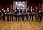 Maj. Gen. Thomas Sherman, Air Force Installation and Mission Support Center commander, and Chief Master Sgt. Ronnie Woods, AFIMSC command chief, pose for a group photo with the 2025 AFIMSC Annual Excellence Award winners during the awards banquet March 26 at Joint Base San Antonio-Lackland, Texas. (U.S. Air Force photo by Luke Allen)