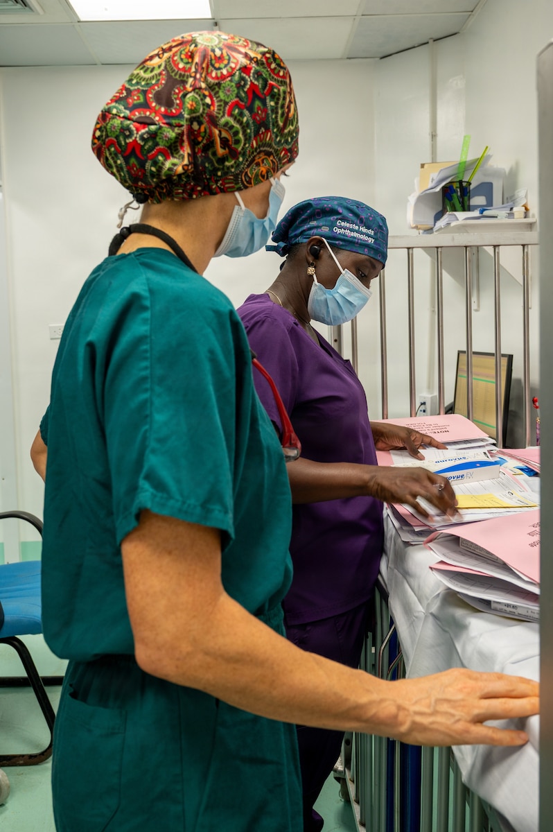 U.S. Air Force Lt. Col. Jessica Bolton, 96th Medical Group ophthalmologist, front, and Dr. Celeste Hines, Guyanese ophthalmologist, review patient records prior to beginning ophthalmological procedures at the Georgetown Public Hospital Corporation in Georgetown, Guyana, March 18, 2026. During the Lesser Antilles Medical Assistance Team (LAMAT) 2026 mission, U.S. Air Force ophthalmology teams performed critical eye procedures alongside Ministry of Health providers, enhancing surgical readiness while improving vision outcomes and strengthening enduring partnerships. (U.S. Air Force photo by Maj. Stephani Schafer)