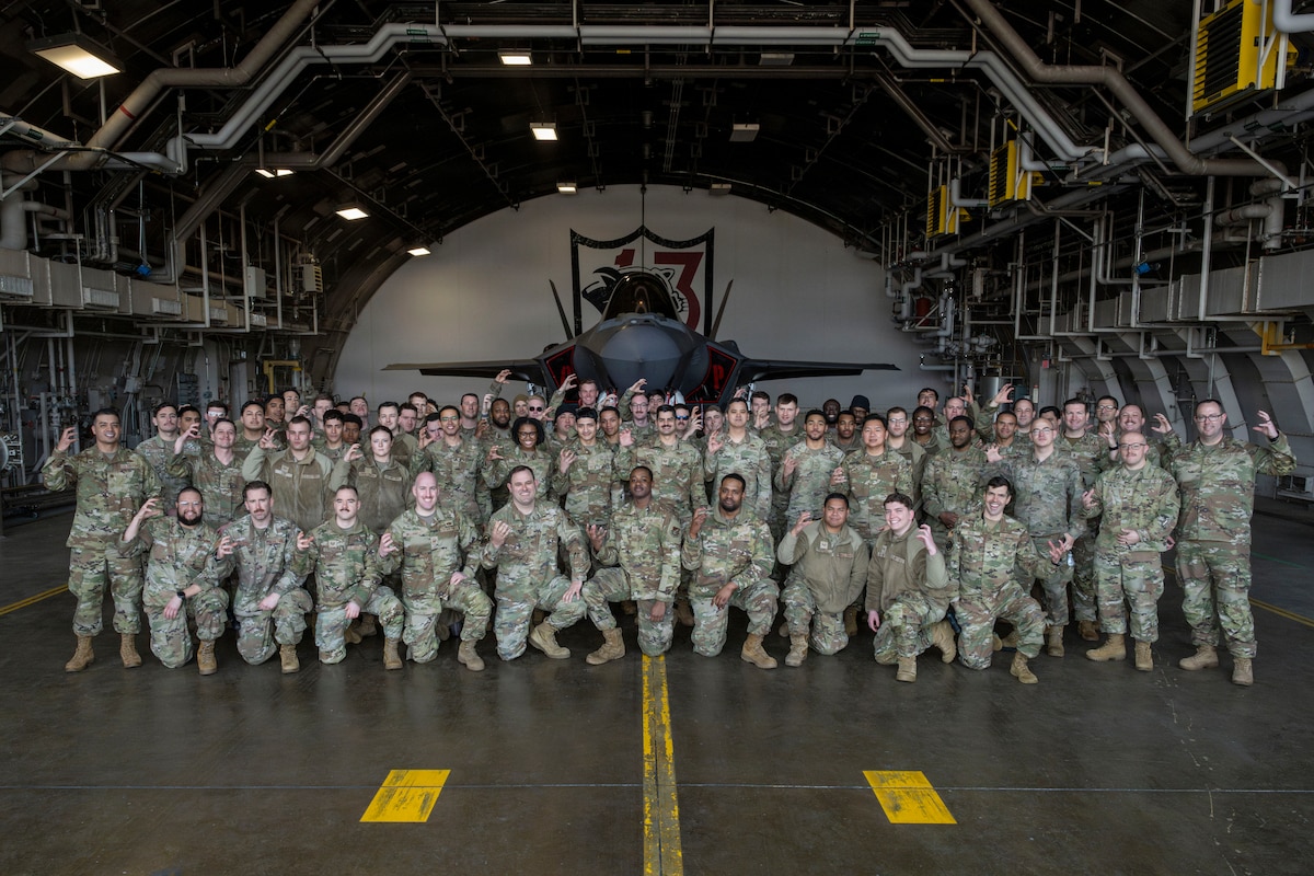 U.S. Airmen assigned to the 13th Fighter Squadron and 13th Fighter Generation Squadron pose for a group photo in front of an F-35A Lightning II during the F-35 first aircraft arrival at Misawa Air Base, Japan, March 28, 2026.