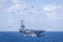 U.S. Navy Carrier Air Wing 8 aircraft fly in formation over the world’s largest aircraft carrier, Ford-class aircraft carrier USS Gerald R. Ford (CVN 78), during Carrier Air Wing 8’s aerial change of command ceremony while underway in the Caribbean Sea, Jan. 19, 2026. U.S. military forces are deployed to the Caribbean in support of the U.S. Southern Command mission, Department of War-directed operations, and the president’s priorities to disrupt illicit drug trafficking and protect the homeland. (U.S. Navy photo)