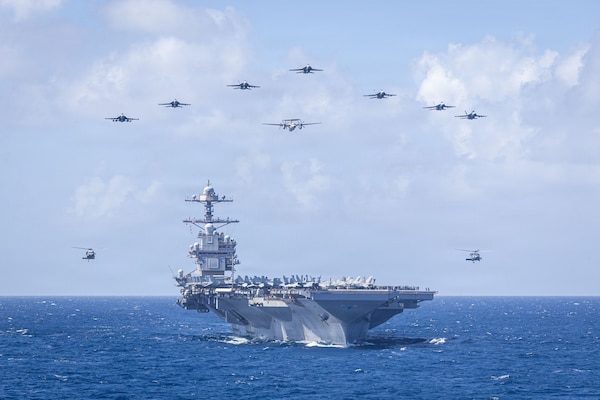 U.S. Navy Carrier Air Wing 8 aircraft fly in formation over the world’s largest aircraft carrier, Ford-class aircraft carrier USS Gerald R. Ford (CVN 78), during Carrier Air Wing 8’s aerial change of command ceremony while underway in the Caribbean Sea, Jan. 19, 2026. U.S. military forces are deployed to the Caribbean in support of the U.S. Southern Command mission, Department of War-directed operations, and the president’s priorities to disrupt illicit drug trafficking and protect the homeland. (U.S. Navy photo)