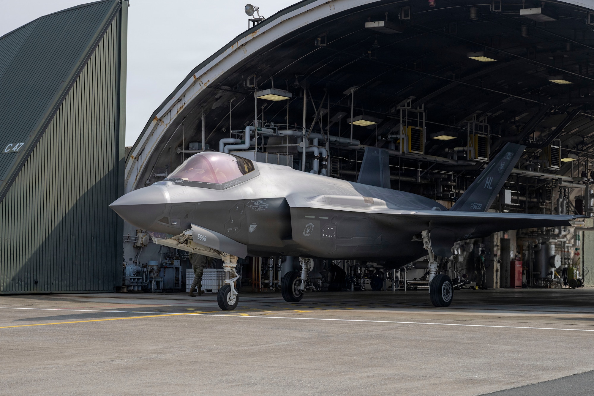 A U.S. Air Force F-35A Lightning II assigned to the 13th Fighter Squadron taxis out of a hangar during the F-35 F-35 Lighting II aircraft arrive at Misawa Air Base, Japan.