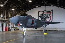 A U.S. Air Force F-35A Lightning II assigned to the 13th Fighter Squadron (FS) sits in a hangar with the 13th FS logo during the F-35 first aircraft arrival at Misawa Air Base, Japan, March 28, 2026.