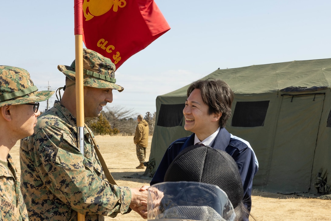 U.S. Marine Corps Gunnery Sgt. Kevin Pelaez, center left, senior enlisted advisor of Combat Logistics Company 36, Combat Logistics Regiment 35, 3rd Marine Logistics Group, and a Pennsylvania native, shakes hands with Satoshi Mitsui, mayor of Tsuyama City after, a tour of CLC-36's base camp during exercise Northern Dragon 26 at Japan Ground Self-Defense Force Camp Nihonbara, Okayama, Japan, March 16, 2026. CLC-36 holds exercise Northern Dragon yearly to enhance and maintain the unit’s logistics capabilities, combat marksmanship proficiency, and medical preparedness in austere terrain and weather conditions. (U.S. Marine Corps photo by Cpl. Colin Thibault)
