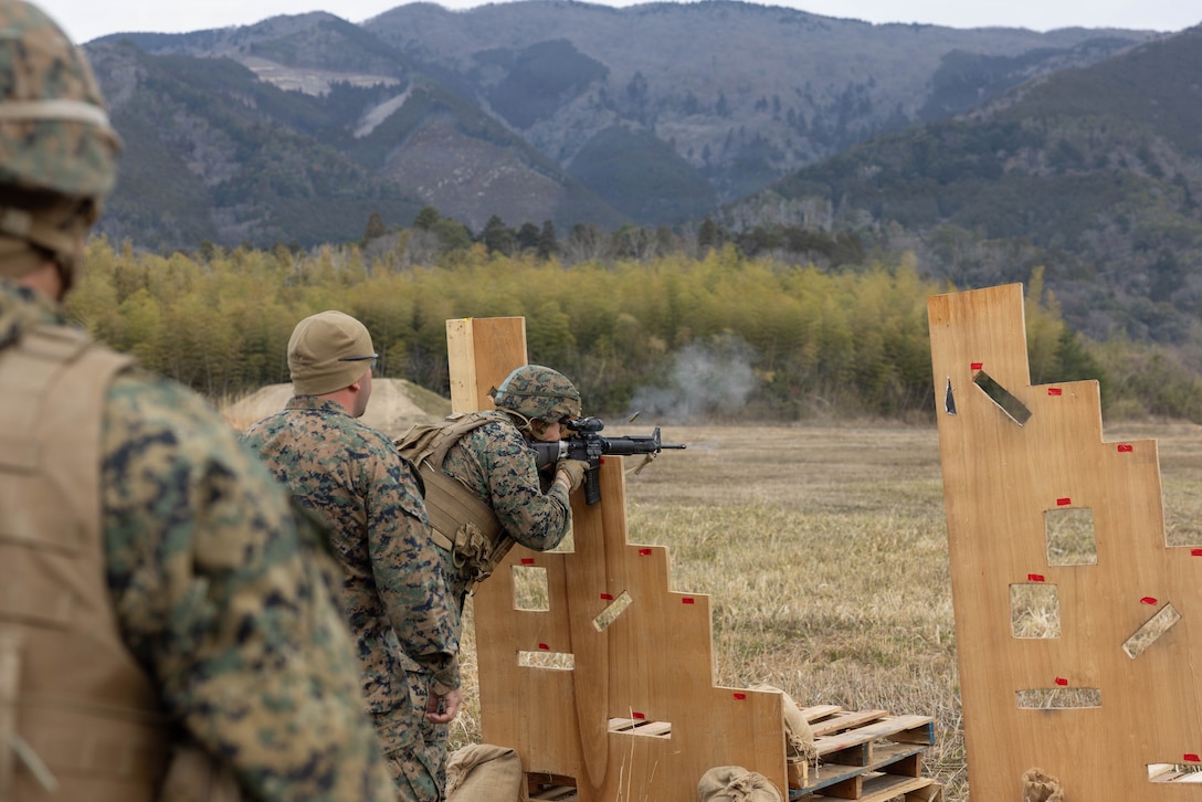 U.S. Marine Corps Cpl. Raul Velasco, center, a combat marksmanship coach with Headquarters and Headquarters Squadron (HHS), Marine Corps Air Station Iwakuni, and a Maryland native, demonstrates the table three course of fire during exercise Northern Dragon 26 at Japan Ground Self-Defense Force Camp Nihonbara, Okayama, Japan, March 17, 2026. Table three evaluates a Marine’s ability to engage targets at unknown distances from supported positions during daylight conditions. Combat Logistics Company 36, Combat Logistics Regiment 35, 3rd Marine Logistics Group holds exercise Northern Dragon yearly to enhance and maintain the unit’s logistics capabilities, combat marksmanship proficiency, and medical preparedness in austere terrain and weather conditions. (U.S. Marine Corps photo by Cpl. Colin Thibault)