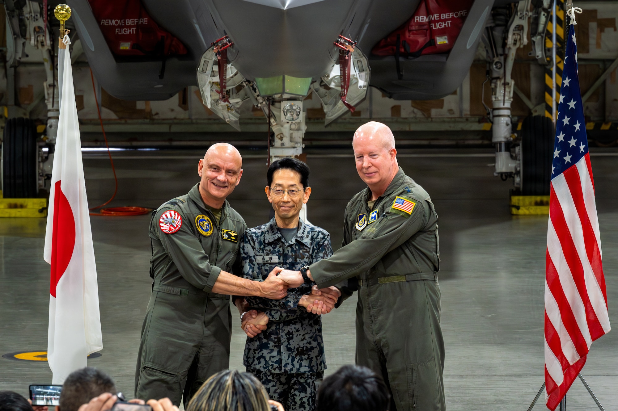 U.S. Air Force Lt. Gen. Joel Carey, right, Fifth Air Force commander, Japan Air Self-Defense Forces Gen. Takehiro Morita, middle, Chief of Staff, and Royal Netherlands Air and Space Force Lt. Gen. André Steur, commander, shake hands during the Exercise Kazaguruma Guardian 26 (KG26) press conference at Misawa Air Base, Japan, March 27, 2026.