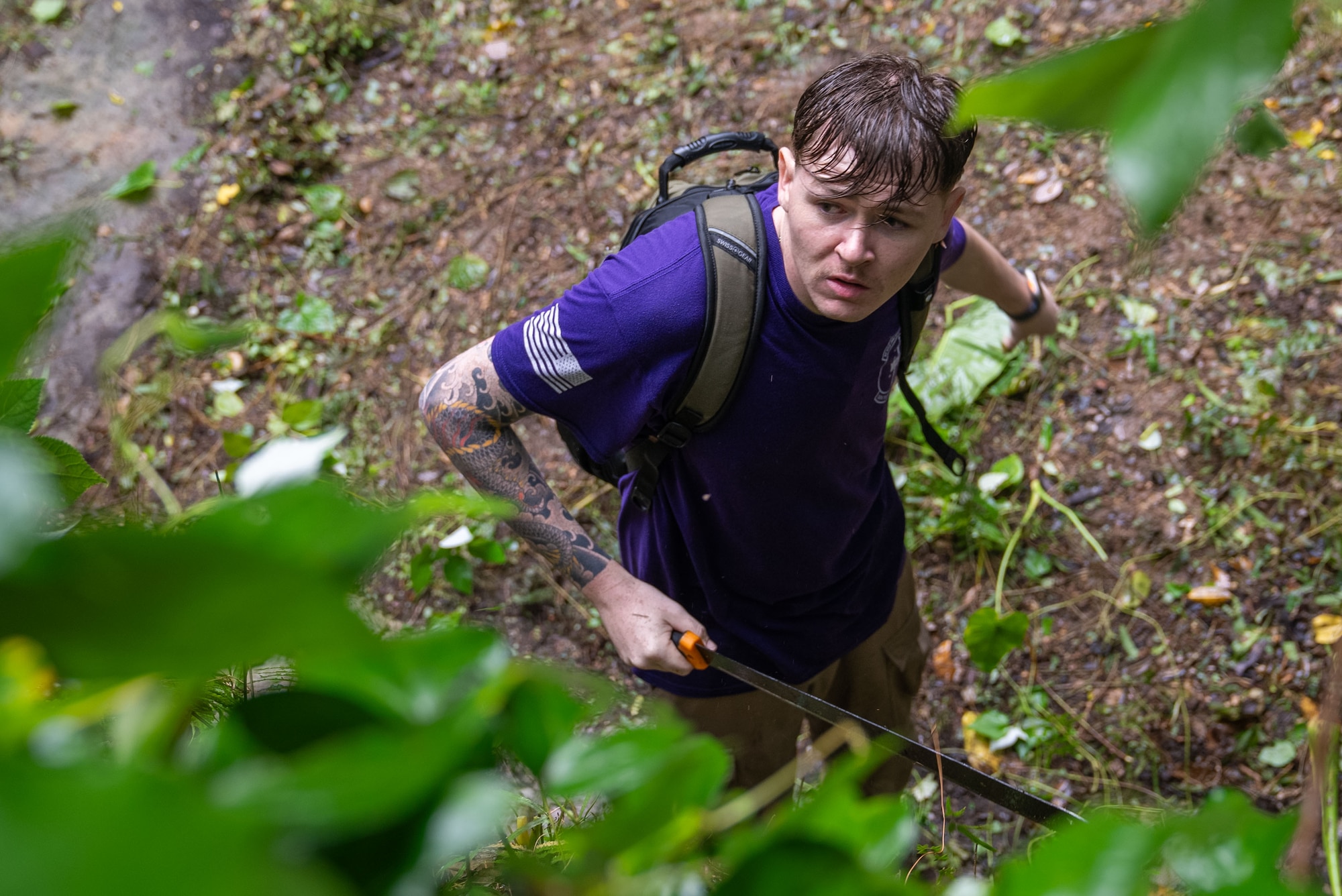 U.S. Air Force Airman 1st Class Gavyn French, 18th Munitions Squadron munitions support equipment maintenance crew chief, cuts vines surrounding an ancestral tomb in preparation for Shimi at Kadena Air Base, Japan, March 25, 2026.