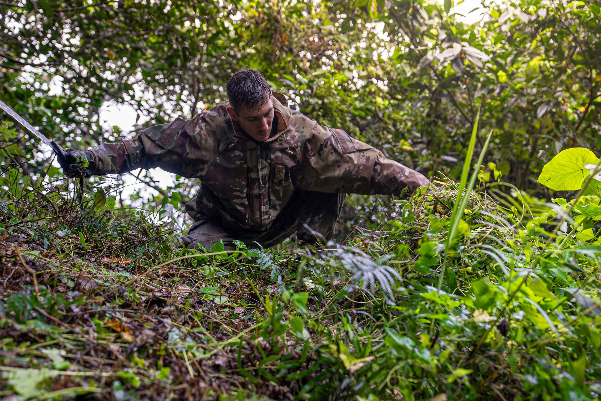 U.S. Air Force Airman 1st Class Garrett Slezak, 18th Munitions Squadron munitions support equipment maintenance crew chief, cuts overgrown vegetation from a tomb in preparation for Shimi at Kadena Air Base, Japan, March 25, 2026.