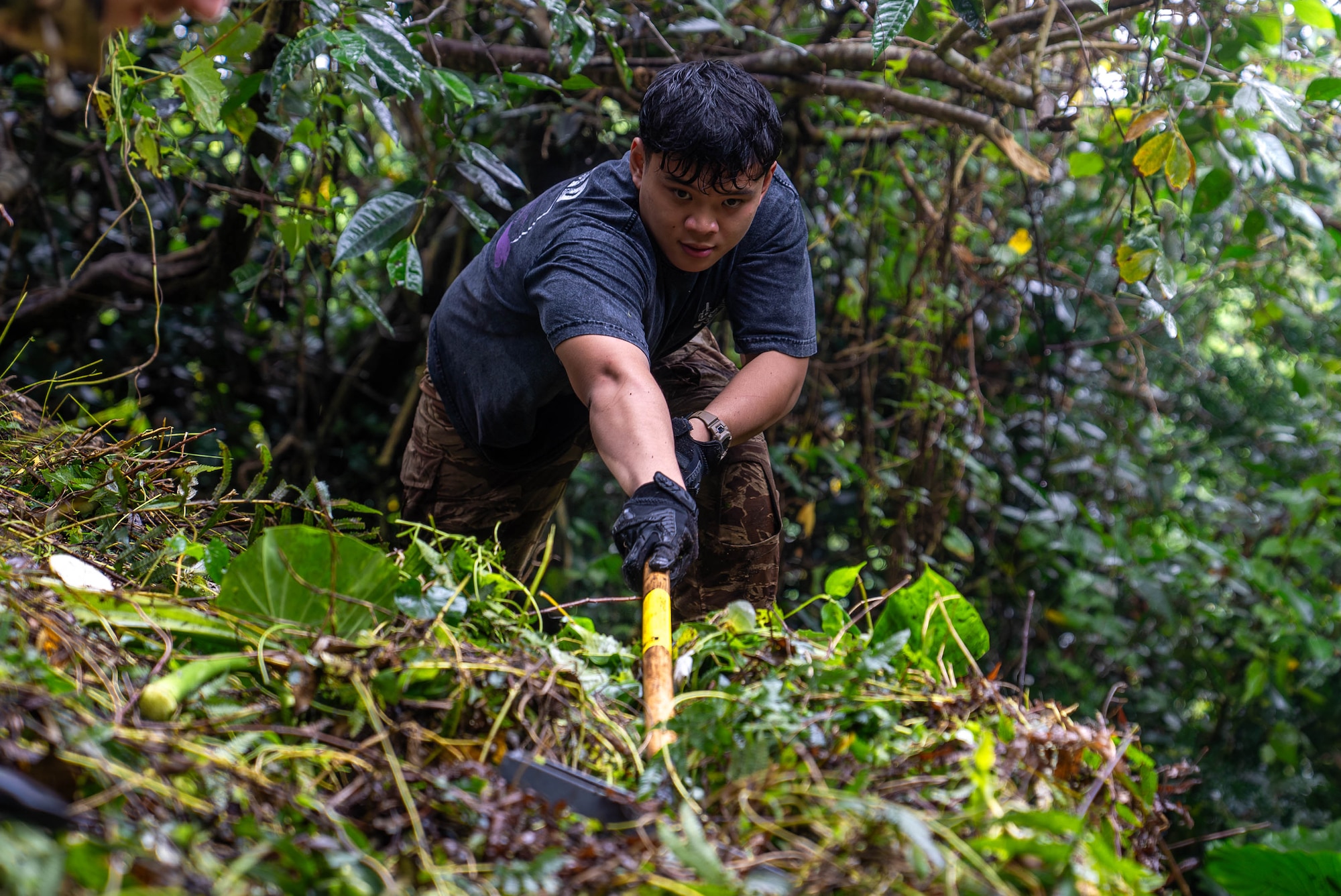 U.S. Air Force Airman 1st Class Long Le, 18th Munitions Squadron precision guided munitions technician, clears overgrown vegetation from an ancestral tomb in preparation for Shimi at Kadena Air Base, Japan, March 25, 2026.