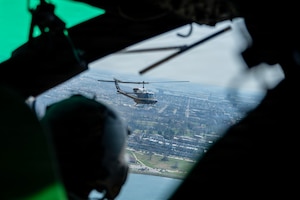 Two UH-1N Hueys, assigned to the 1st Helicopter Squadron, fly toward Oriole Park at Camden Yards, Maryland, March 26, 2026. Upon completion of a flyover for the Baltimore Orioles’ opening day, the 1st HS conducted training to practice formation landing and takeoff safety procedures. (U.S. Air Force photo by Staff Sgt. Aubree Owens)